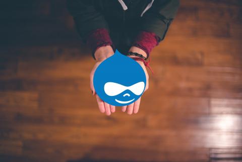 Hands offering a Drupal logo
