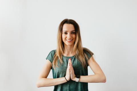 Woman with hands in prayer pose