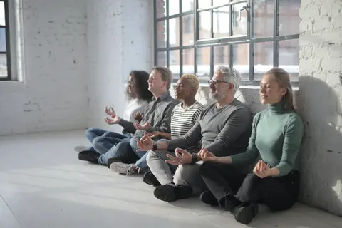 Diverse group of people meditating together