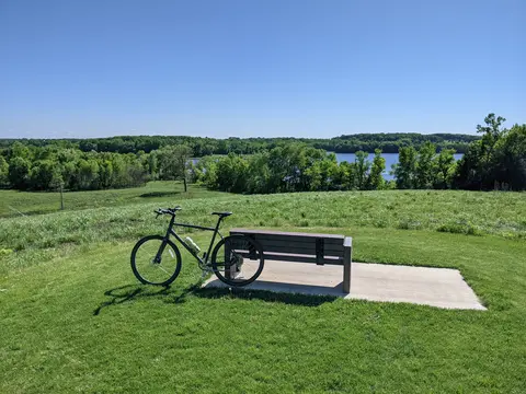 Bike leaning against a bench in a park