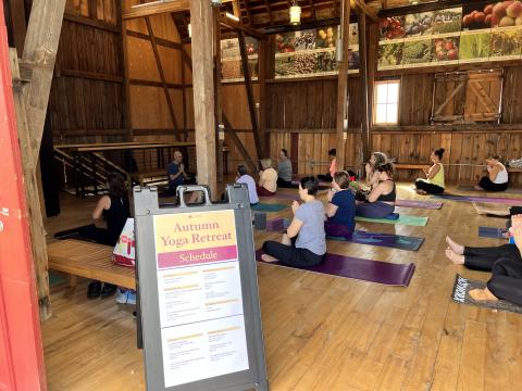 A yoga class from the side of the red bard with a sign showing the class schedule