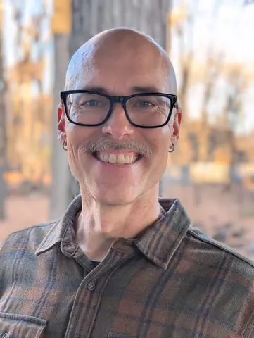 Matthew with a grey mustache outside in Movember 2025