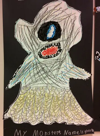 A child's drawing of a ghost-monster with one large blue eye and a wide red mouth full of teeth, on black paper. The caption reads 'My monster's name is ghost.'