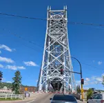 Duluth's Aerial Lift Bridge with its span raised, stopping traffic at a red light and lowered gate.