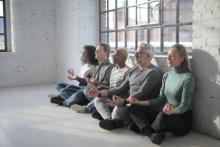Diverse group of people meditating together