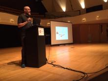Matthew on a stage giving the keynote speech at DrupalCamp Colorado