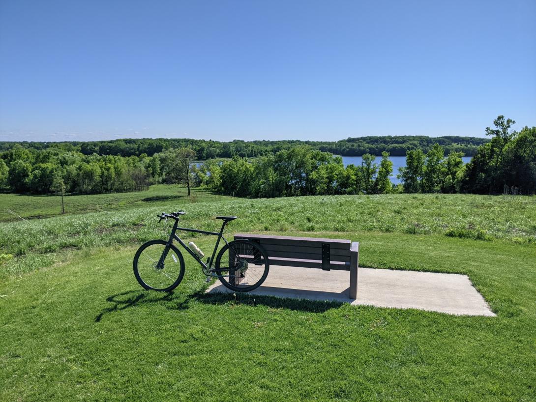 Bike leaning against a bench in a park