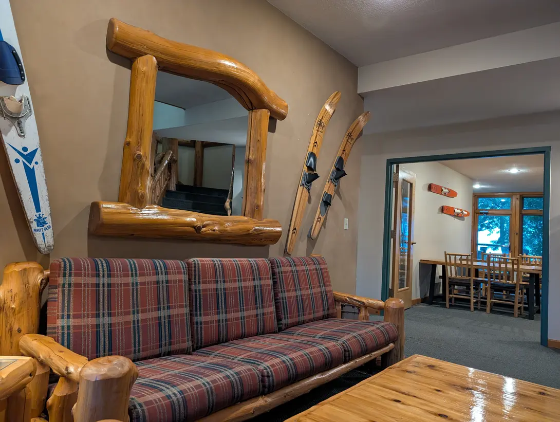 a couch in a lobby with water skis on the walls