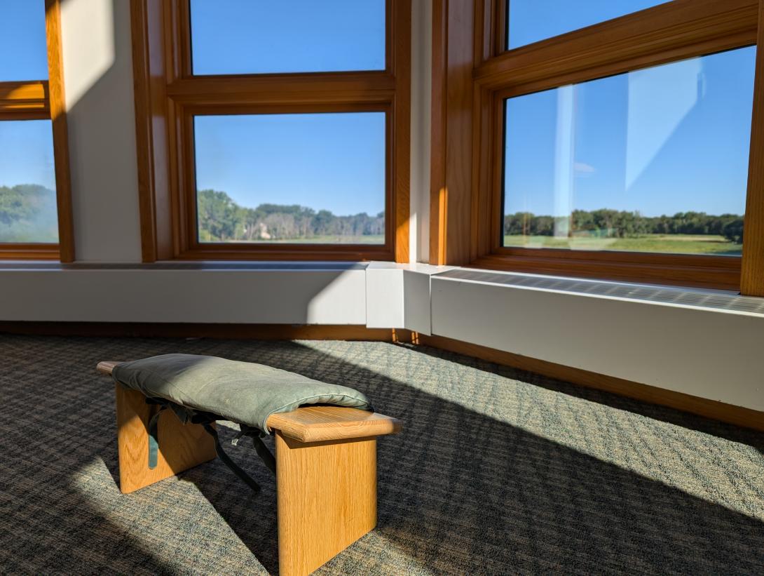 a meditation bench near a window